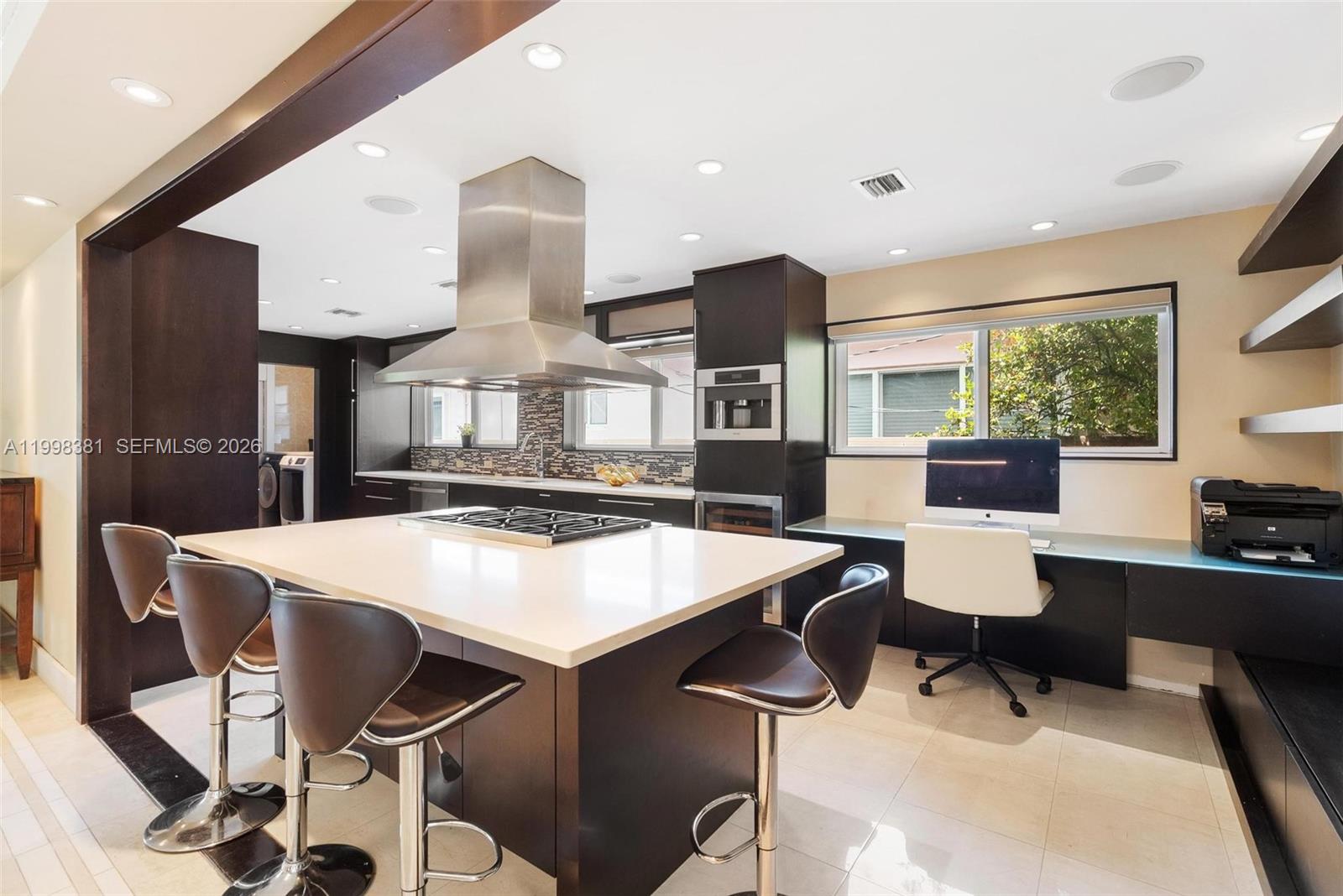 9141 Abbott Avenue Surfside, FL 33154 - Photo 7 of 31 a large kitchen with a table and chairs