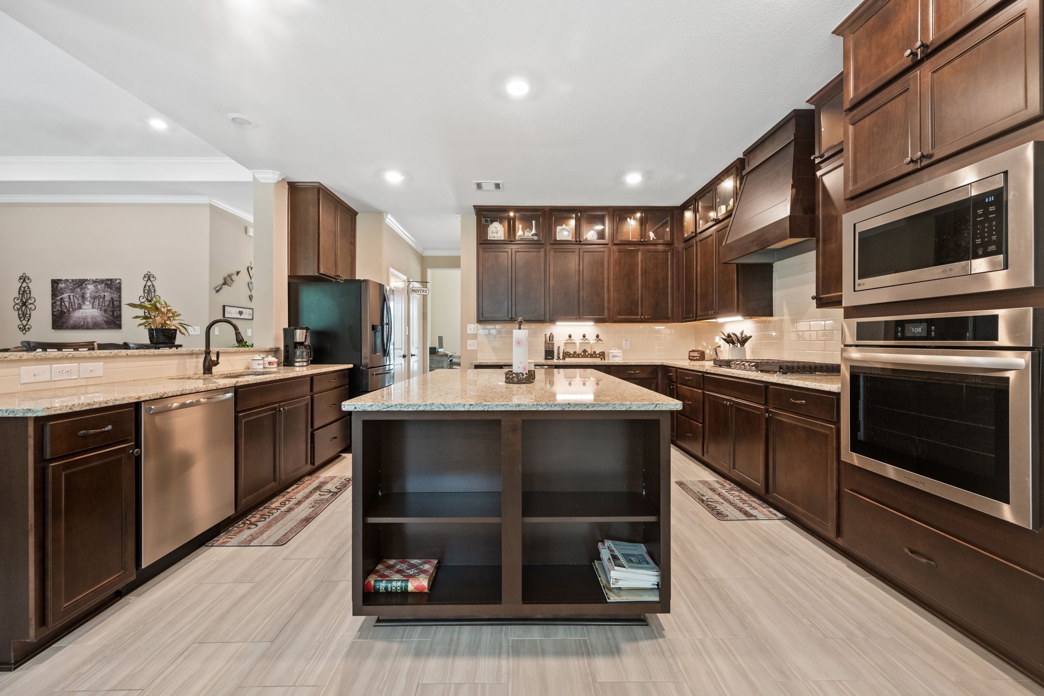 3004 Tyler Street Dayton, TX 77535 - Photo 13 of 34 a kitchen with a sink cabinets and stainless steel appliances