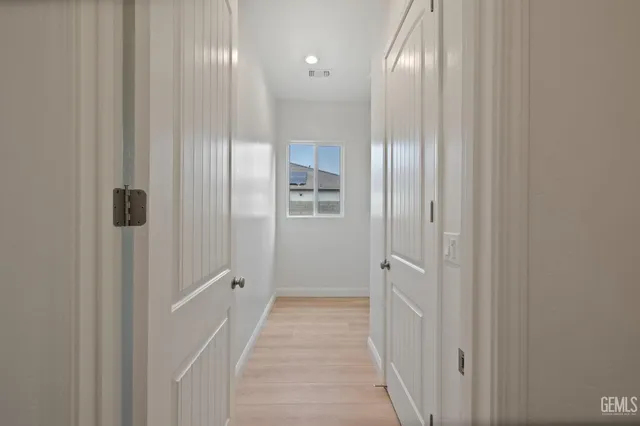 a view of a hallway with wooden floor