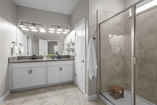 a kitchen with stainless steel appliances a table chairs and a refrigerator