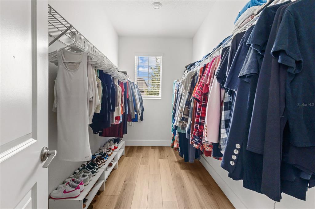 4465 Tubular Run Land O Lakes, FL 34638 - Photo 16 of 60 a view of walk in closet with clothes and shoes