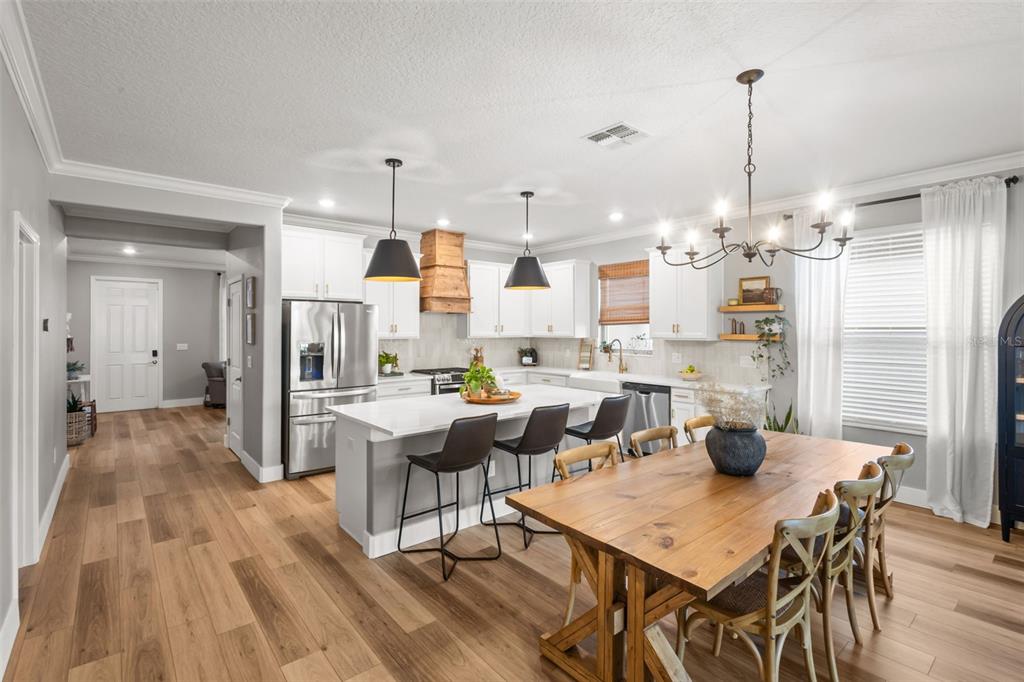 4465 Tubular Run Land O Lakes, FL 34638 - Photo 18 of 60 a view of a dining room and livingroom with furniture wooden floor a chandelier