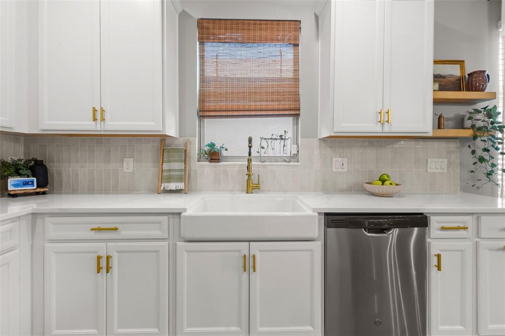 4465 Tubular Run Land O Lakes, FL 34638 - Photo 21 of 60 a kitchen with stainless steel appliances granite countertop a sink a stove and white cabinets