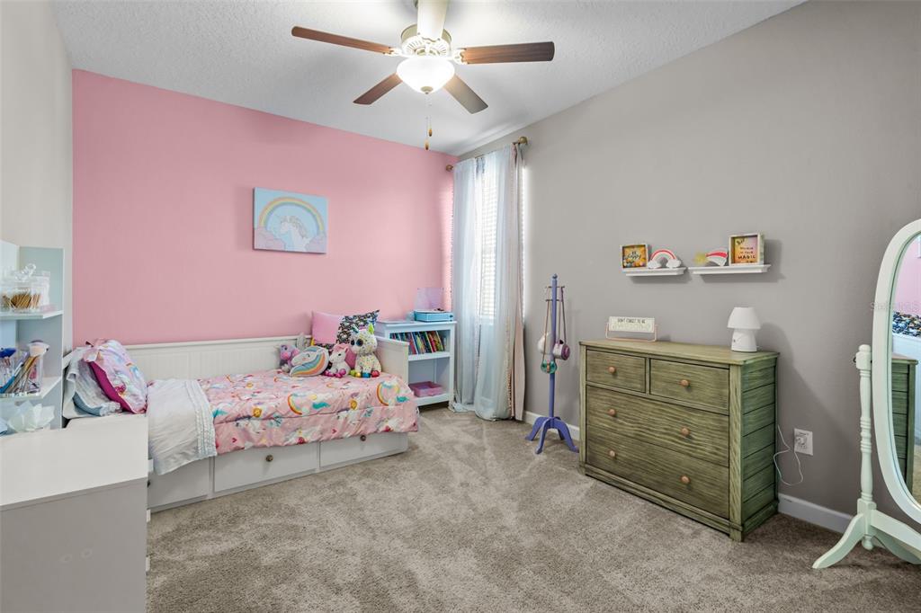 4465 Tubular Run Land O Lakes, FL 34638 - Photo 30 of 60 a bedroom with a bed and a ceiling fan