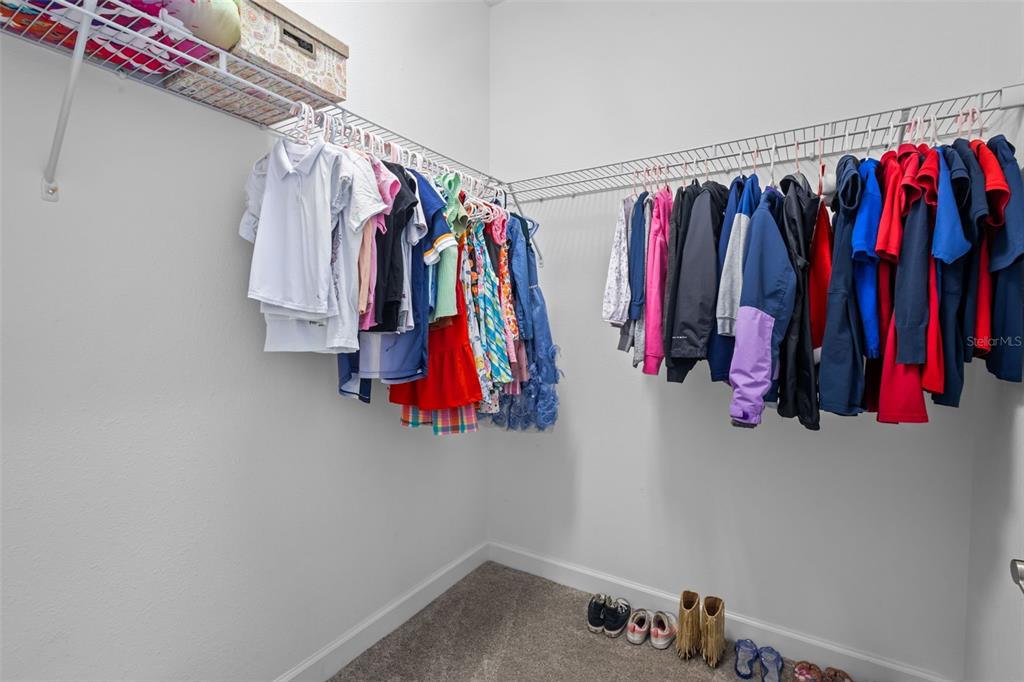 4465 Tubular Run Land O Lakes, FL 34638 - Photo 32 of 60 a view of walk in closet with clothes
