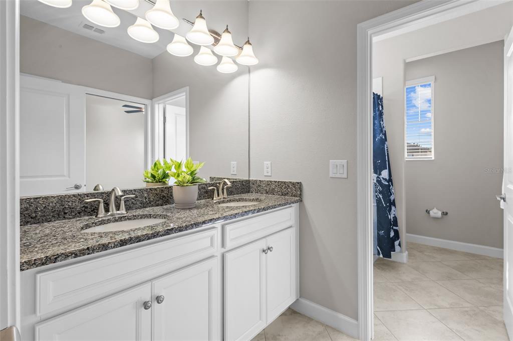 4465 Tubular Run Land O Lakes, FL 34638 - Photo 36 of 60 a bathroom with a sink double vanity and a mirror