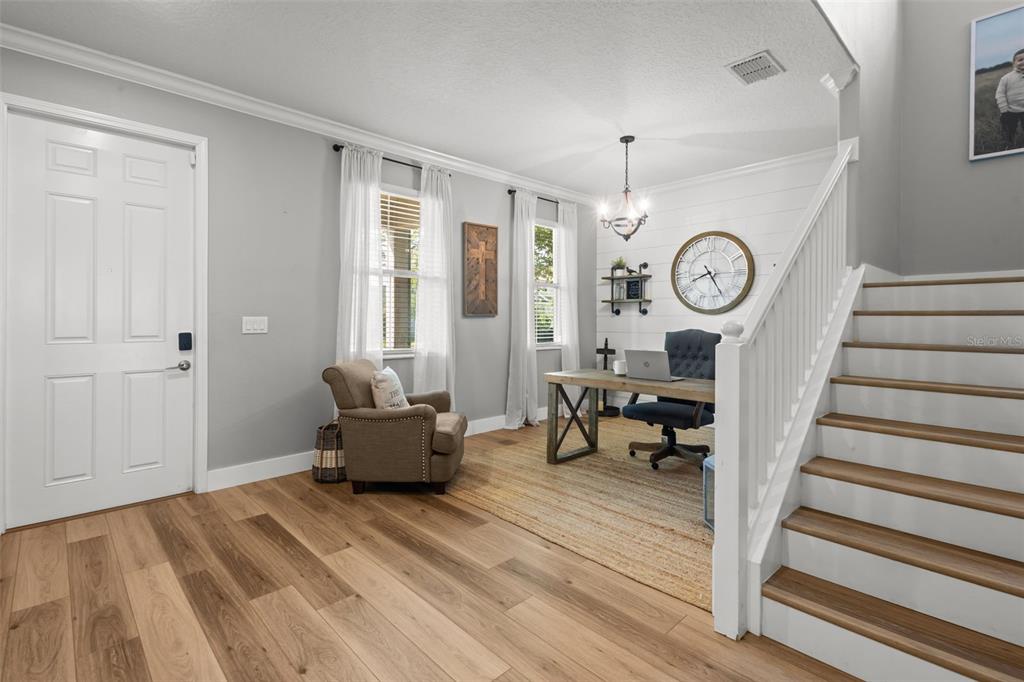 4465 Tubular Run Land O Lakes, FL 34638 - Photo 10 of 60 a living room with furniture and a clock
