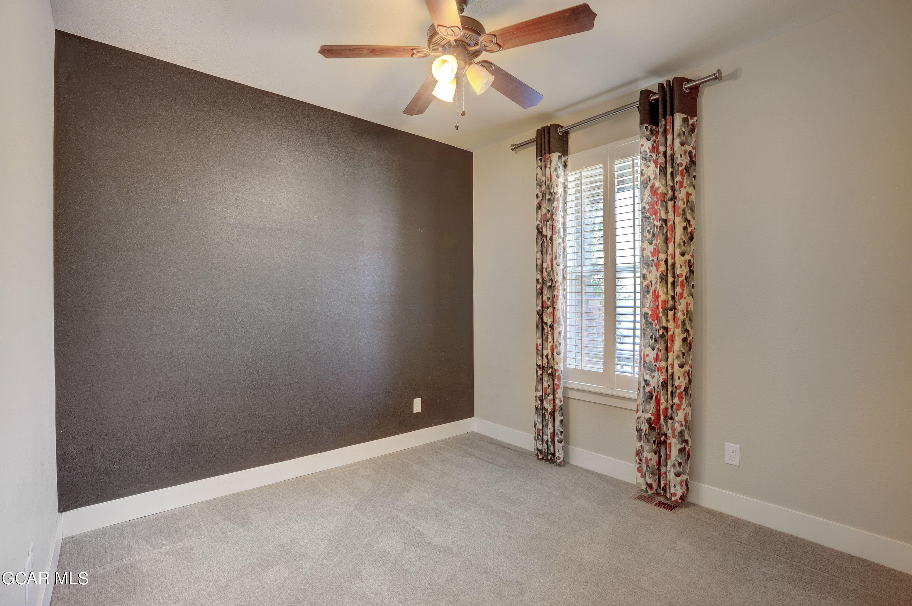 15526 Red Deer Drive Morrison, CO 80465 - Photo 14 of 82 an empty room with windows and fan