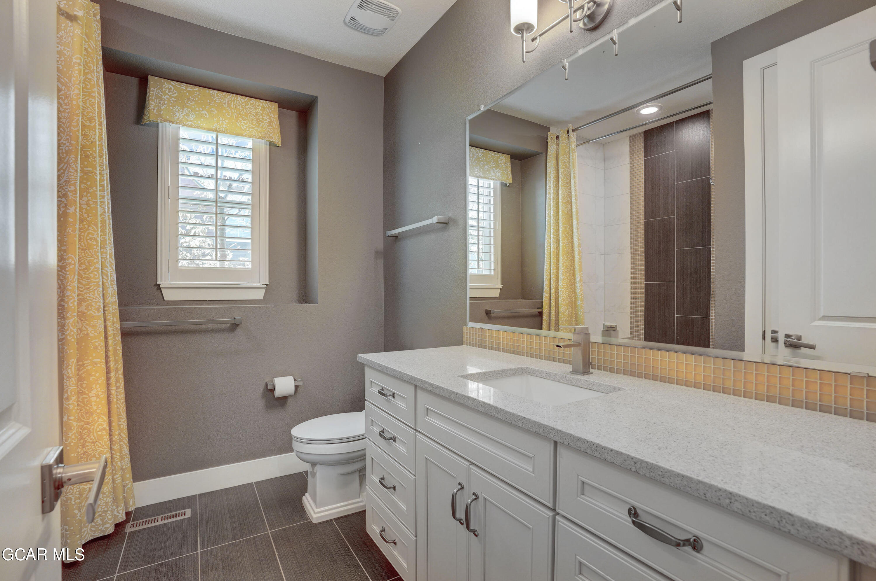 15526 Red Deer Drive Morrison, CO 80465 - Photo 16 of 82 a bathroom with a sink a toilet and a large mirror