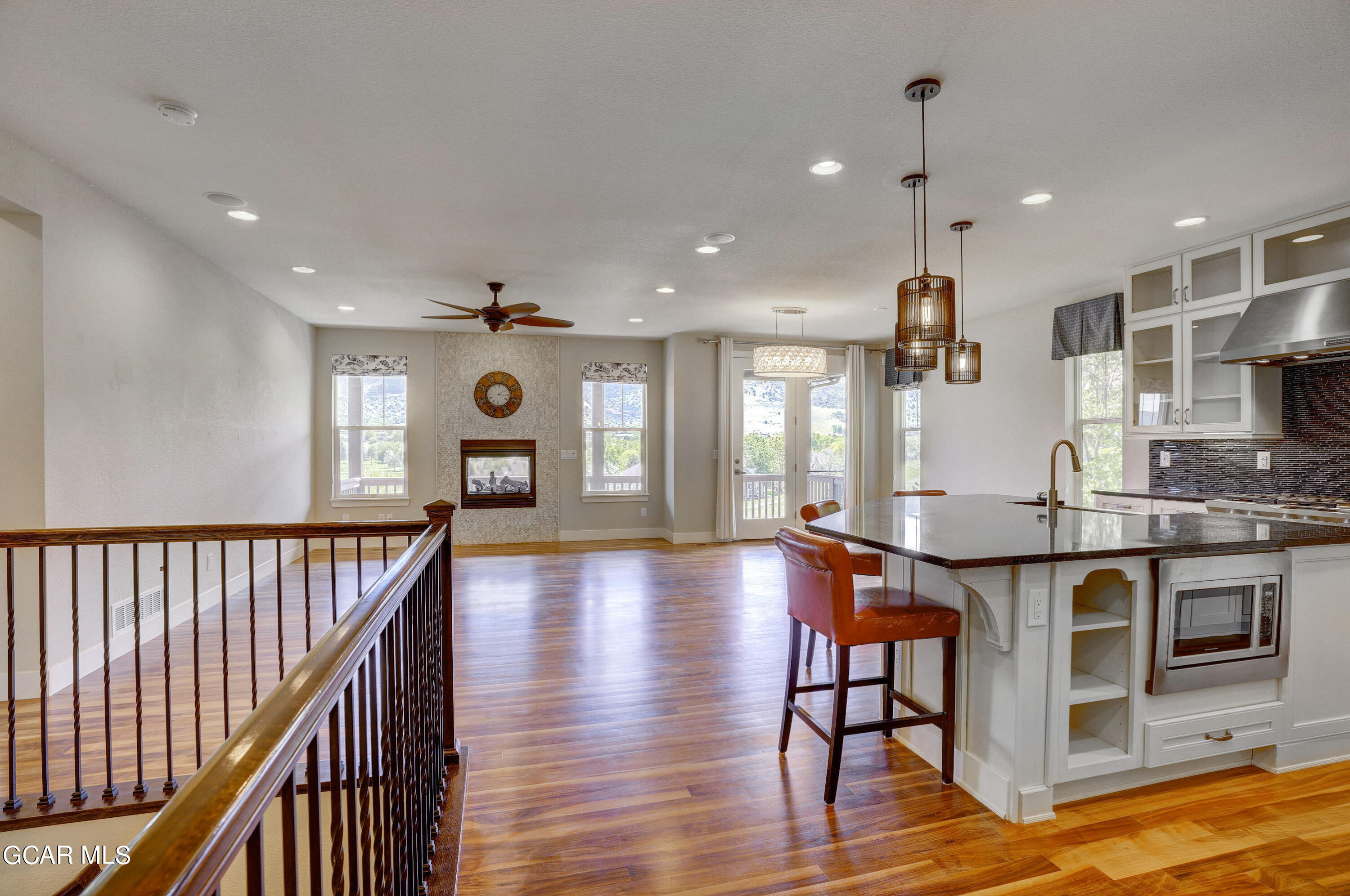 15526 Red Deer Drive Morrison, CO 80465 - Photo 22 of 82 a open kitchen with stainless steel appliances granite countertop a stove and a wooden floors