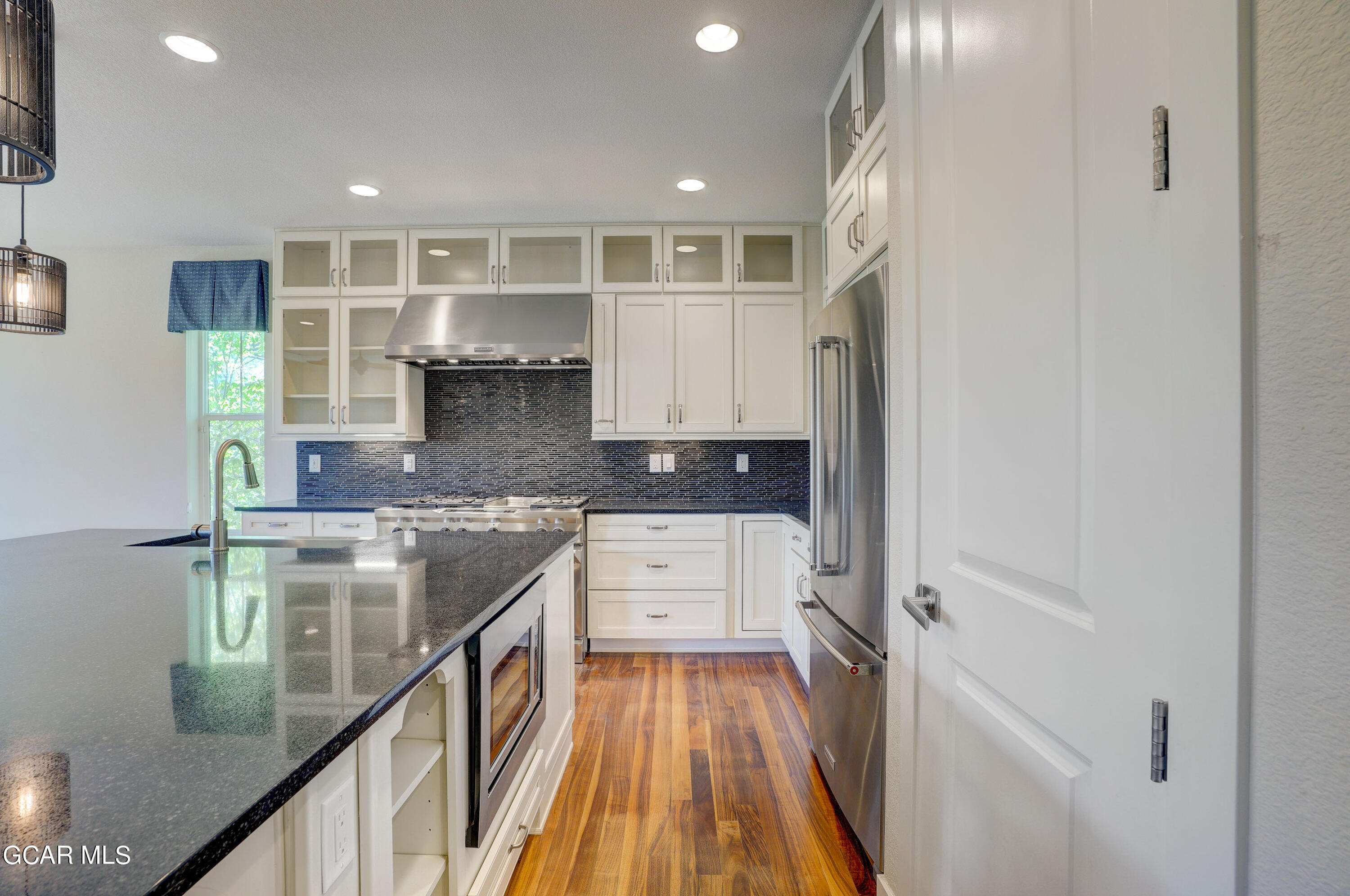 15526 Red Deer Drive Morrison, CO 80465 - Photo 23 of 82 a kitchen with stainless steel appliances granite countertop a refrigerator and a stove