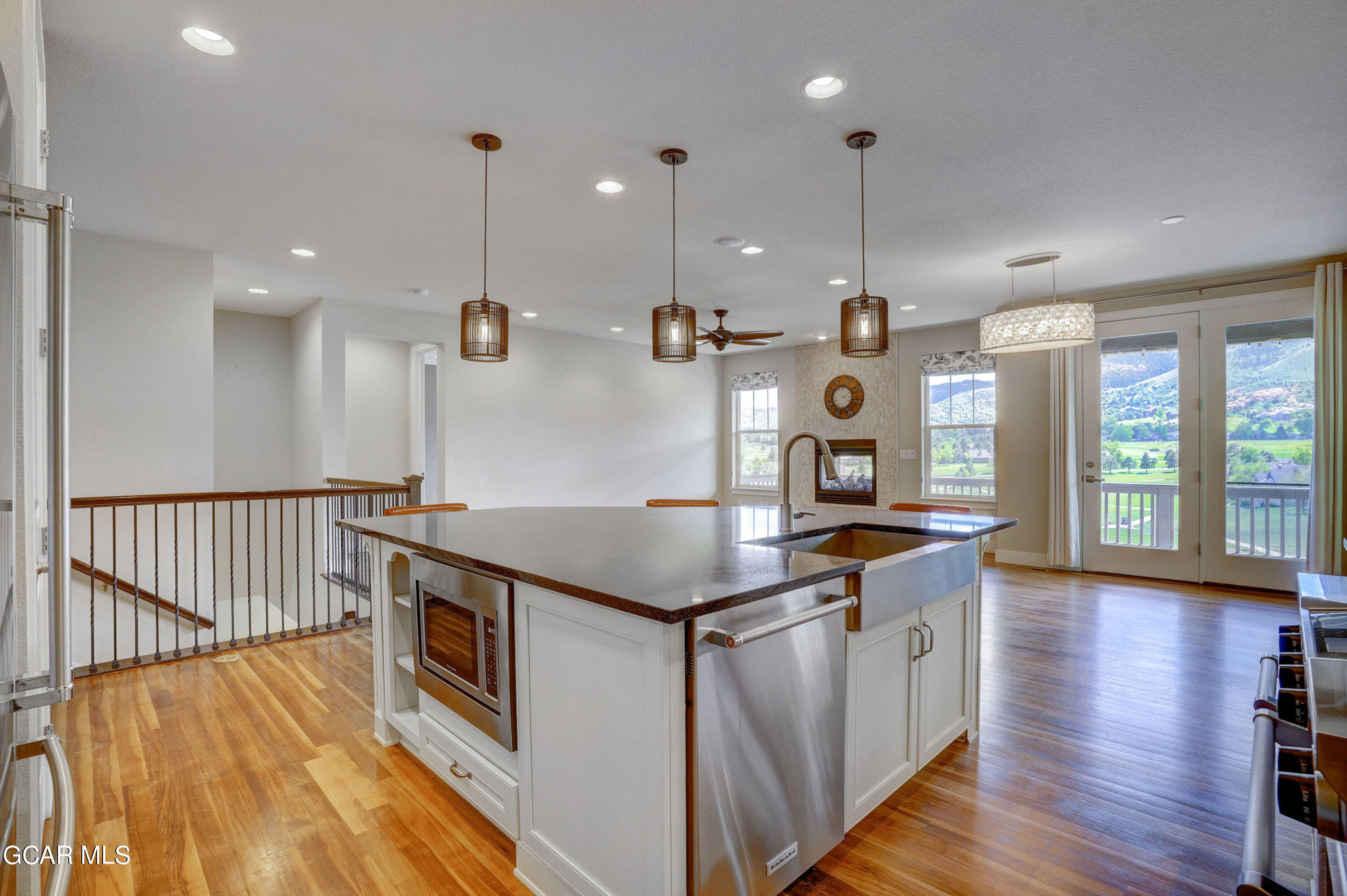 15526 Red Deer Drive Morrison, CO 80465 - Photo 25 of 82 a kitchen with stainless steel appliances granite countertop a stove and wooden floor