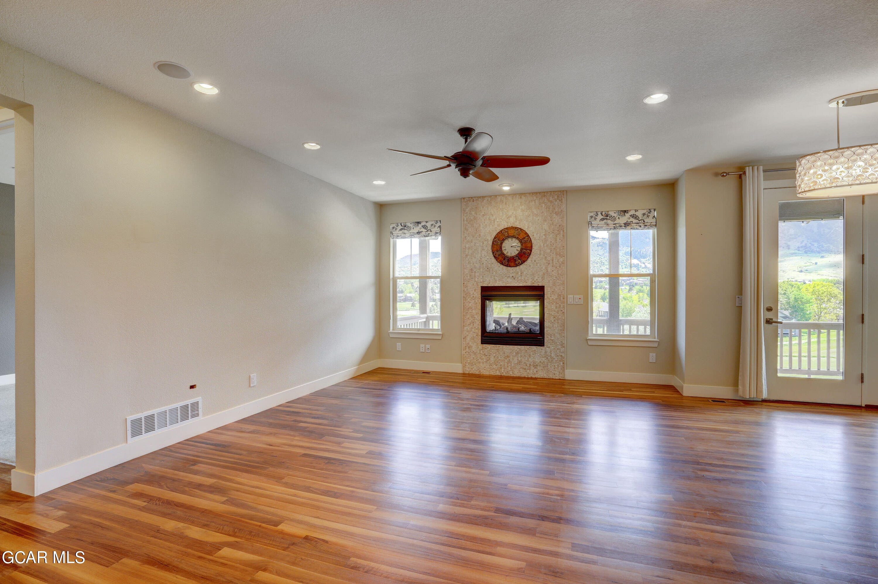 15526 Red Deer Drive Morrison, CO 80465 - Photo 26 of 82 a view of an empty room with a fireplace and a window