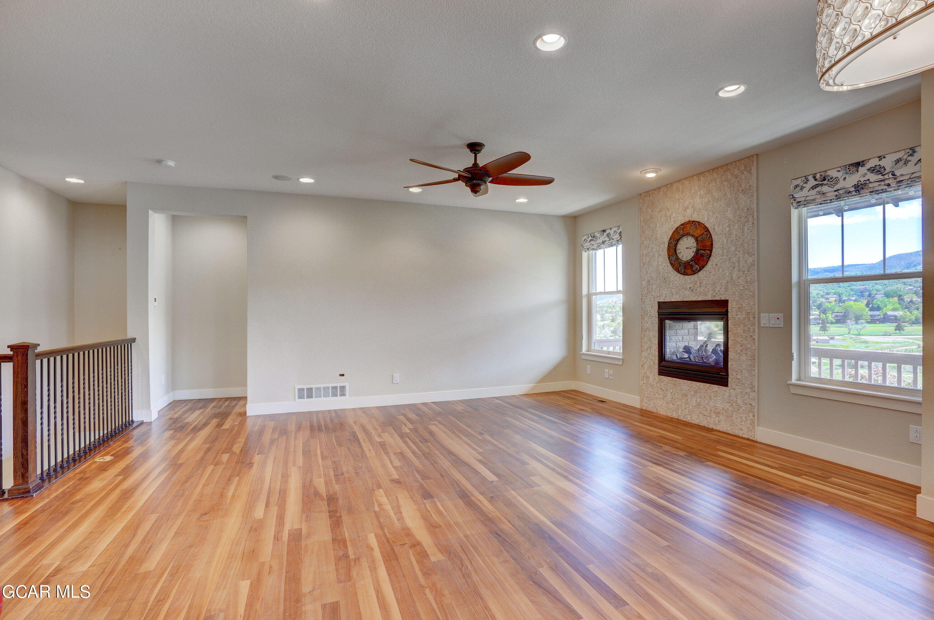 15526 Red Deer Drive Morrison, CO 80465 - Photo 27 of 82 an empty room with wooden floor and windows