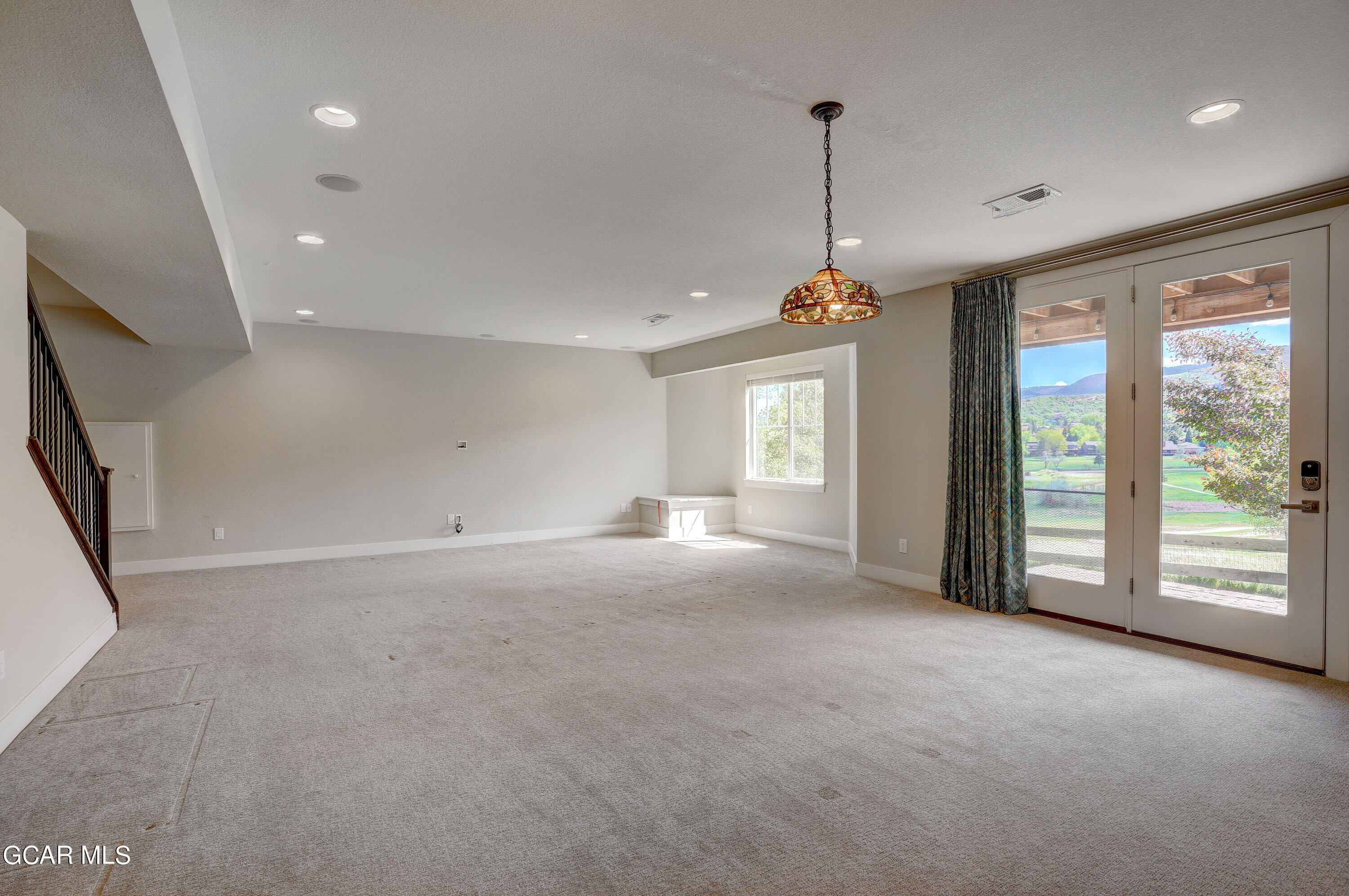 15526 Red Deer Drive Morrison, CO 80465 - Photo 40 of 82 a view of empty room with windows and ceiling fan