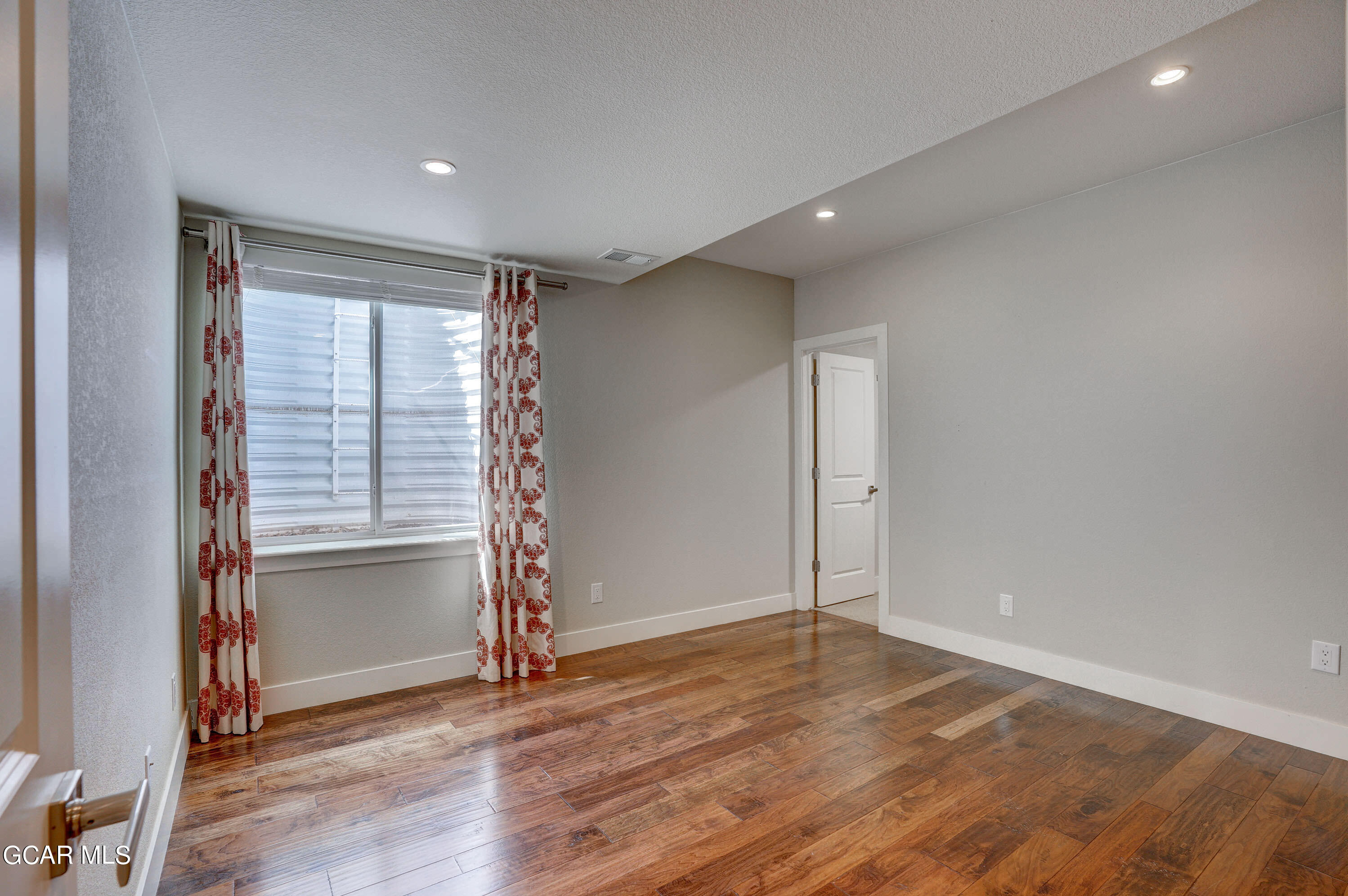 15526 Red Deer Drive Morrison, CO 80465 - Photo 46 of 82 an empty room with wooden floor and a window