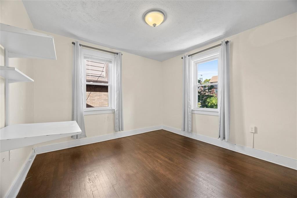 1534 McFarland Road Pittsburgh, PA 15216 - Photo 17 of 36 a view of a livingroom with wooden floor and a window