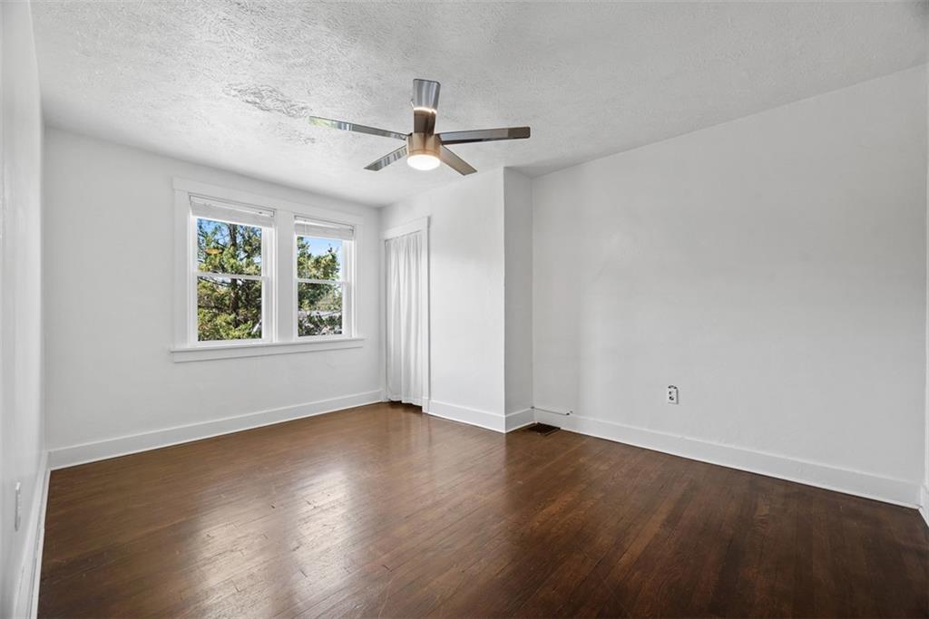 1534 McFarland Road Pittsburgh, PA 15216 - Photo 19 of 36 an empty room with wooden floor chandelier fan and windows