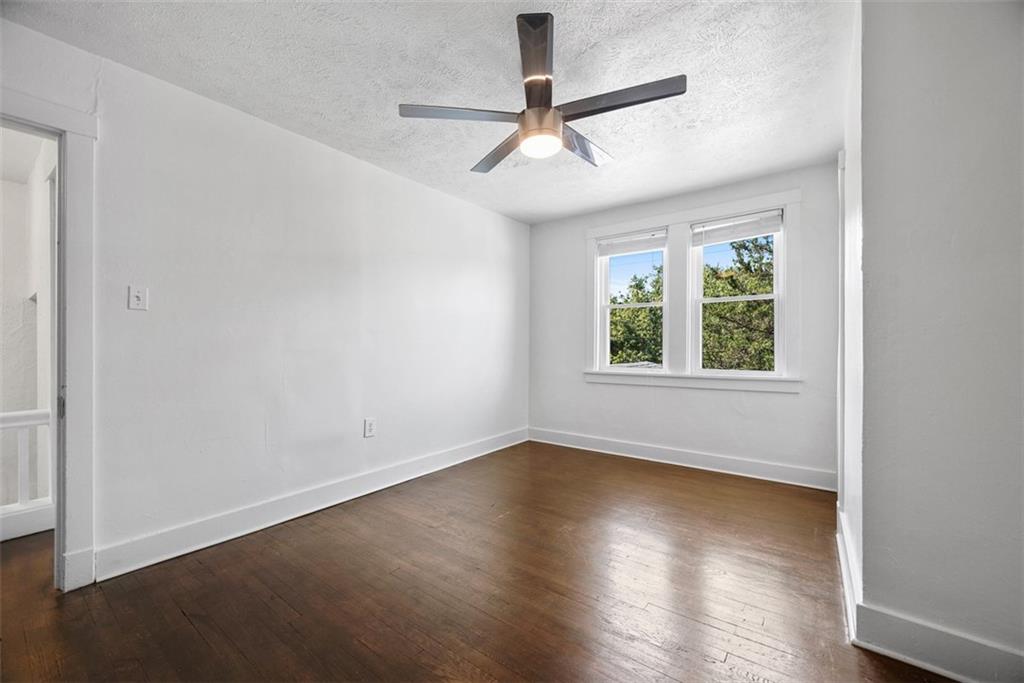 1534 McFarland Road Pittsburgh, PA 15216 - Photo 20 of 36 an empty room with wooden floor chandelier and windows