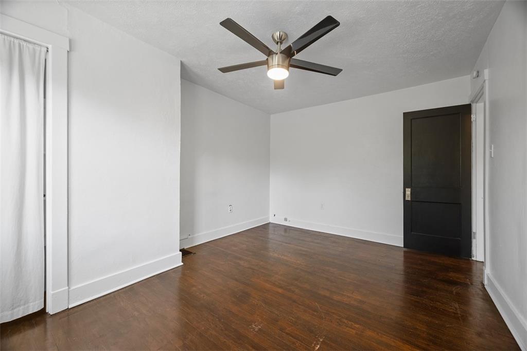 1534 McFarland Road Pittsburgh, PA 15216 - Photo 21 of 36 an empty room with wooden floor and a ceiling fan