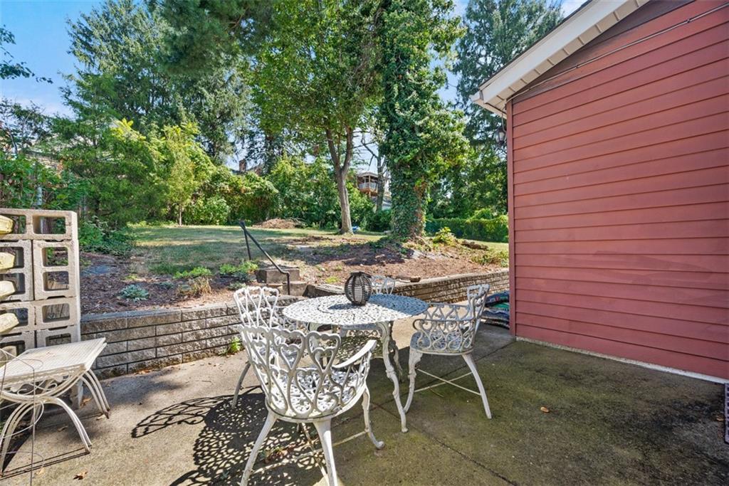 1534 McFarland Road Pittsburgh, PA 15216 - Photo 29 of 36 a view of a patio with table and chairs with wooden fence and plants
