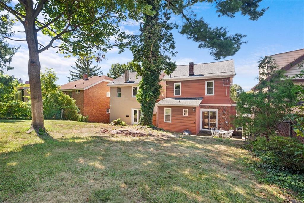 1534 McFarland Road Pittsburgh, PA 15216 - Photo 32 of 36 a backyard of a house with large trees and a barn