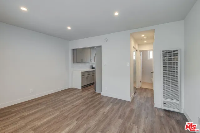 a view of a kitchen with a sink and a refrigerator