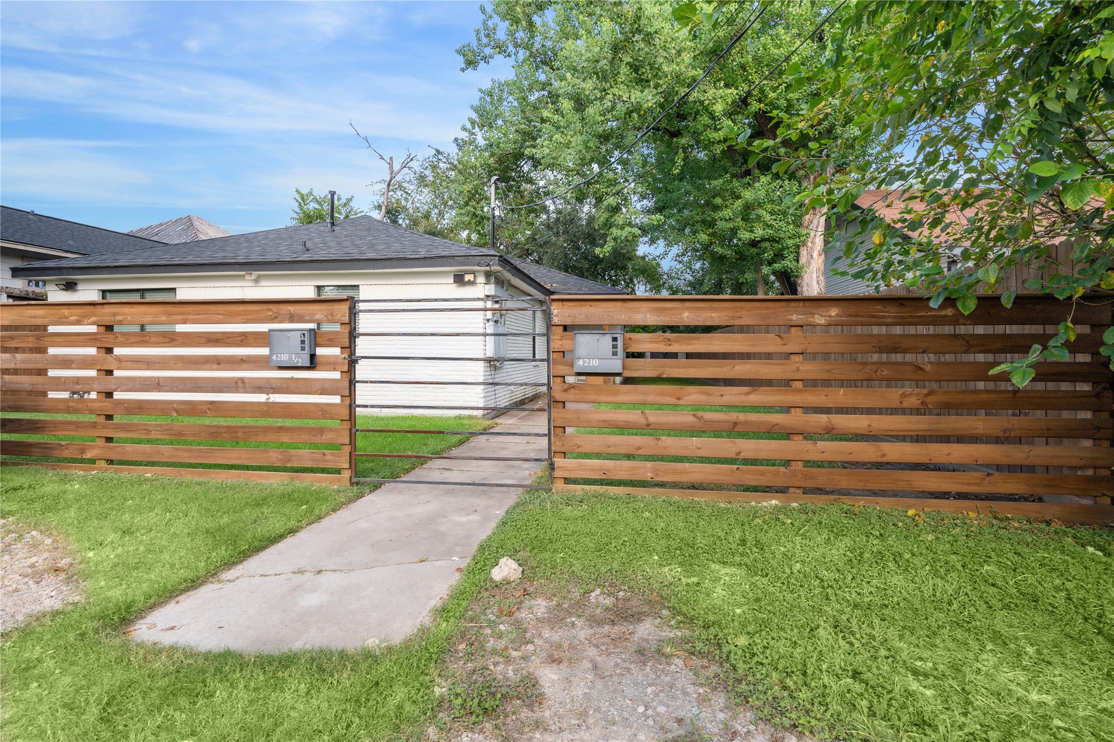 4210 Delhi Street, Unit 1/2 Houston, TX 77022 - Photo 1 of 8 a view of a backyard with a large tree