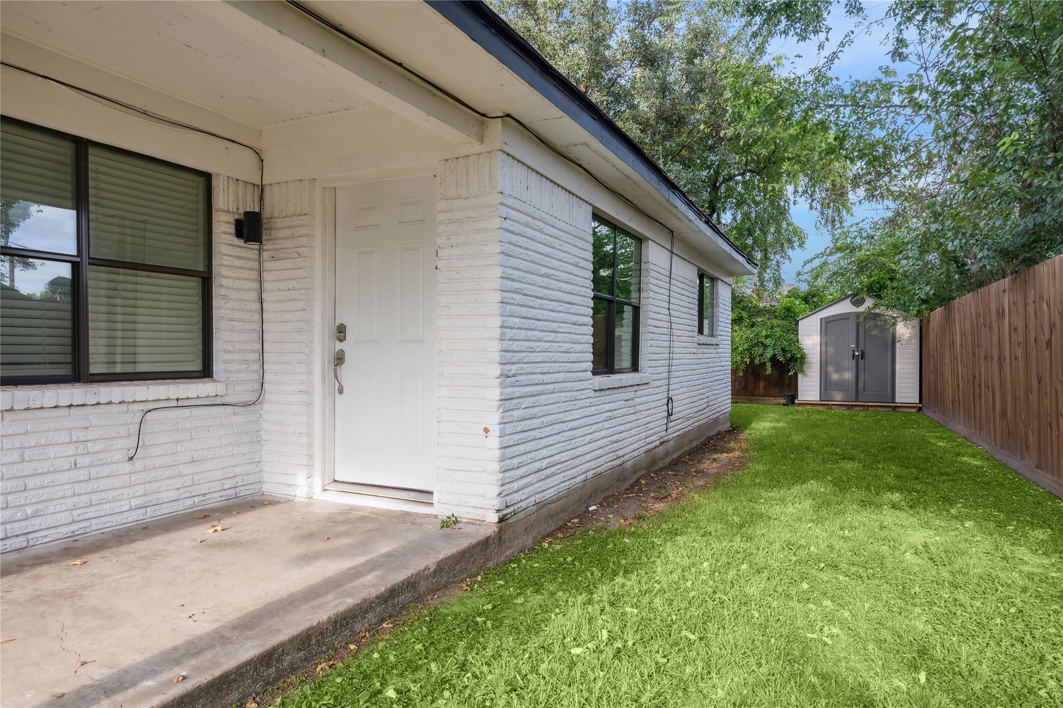 4210 Delhi Street, Unit 1/2 Houston, TX 77022 - Photo 3 of 8 a view of a backyard with large trees and wooden fence
