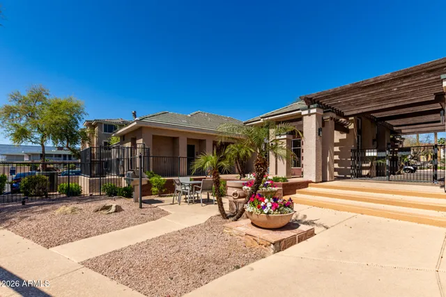 a view of a patio with table and chairs potted plants and palm trees