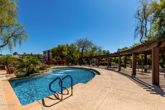 a swimming pool with outdoor seating and yard