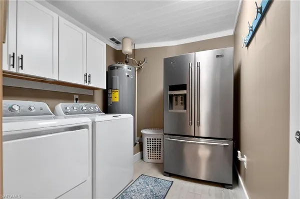 a kitchen with refrigerator and washer