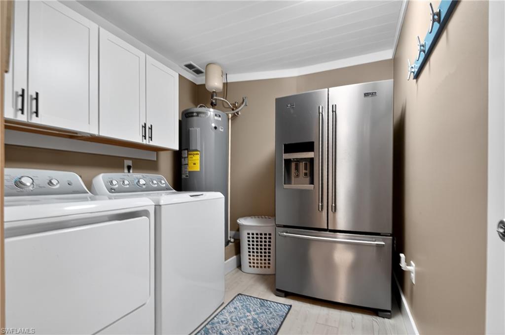 190 Tahiti Circle Naples, FL 34113 - Photo 12 of 32 a kitchen with refrigerator and washer