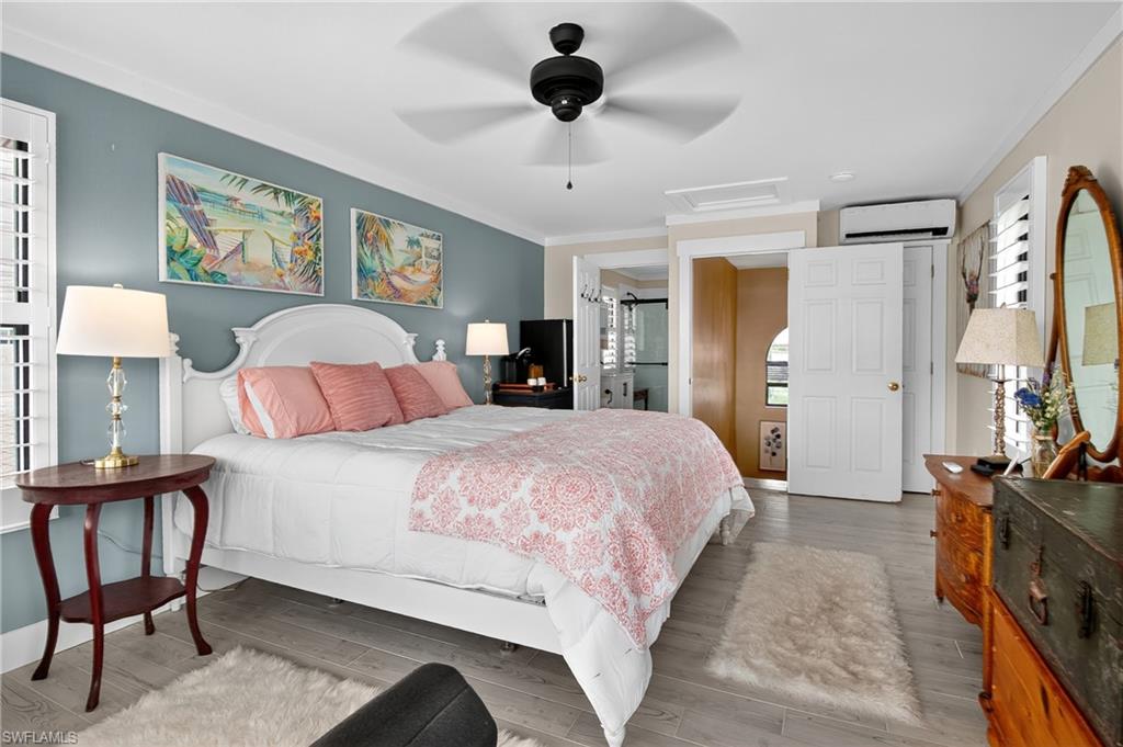 190 Tahiti Circle Naples, FL 34113 - Photo 14 of 32 a bedroom with a bed a dresser and chair