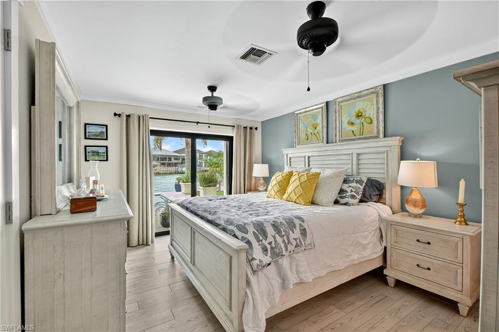 190 Tahiti Circle Naples, FL 34113 - Photo 16 of 32 a bedroom with a bed and large windows