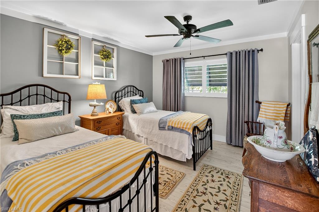 190 Tahiti Circle Naples, FL 34113 - Photo 18 of 32 a bedroom with two beds and windows