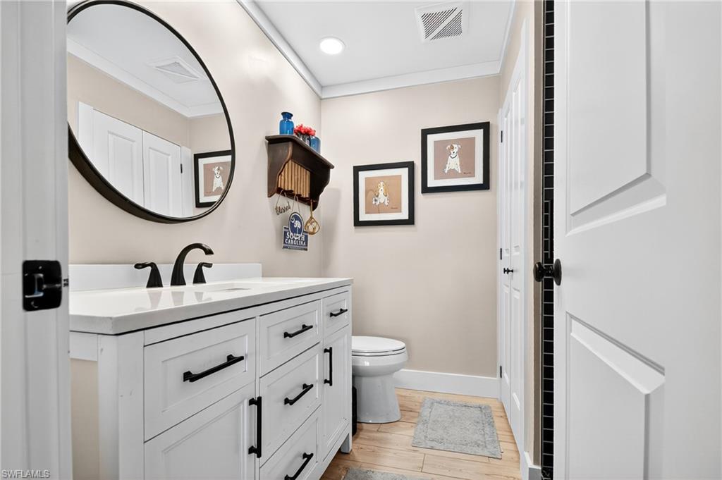190 Tahiti Circle Naples, FL 34113 - Photo 19 of 32 a bathroom with a sink and a mirror