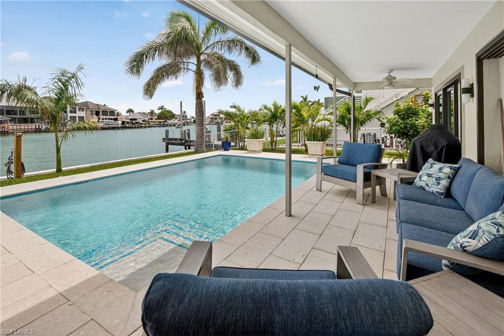 190 Tahiti Circle Naples, FL 34113 - Photo 22 of 32 a view of swimming pool with outdoor seating and a patio