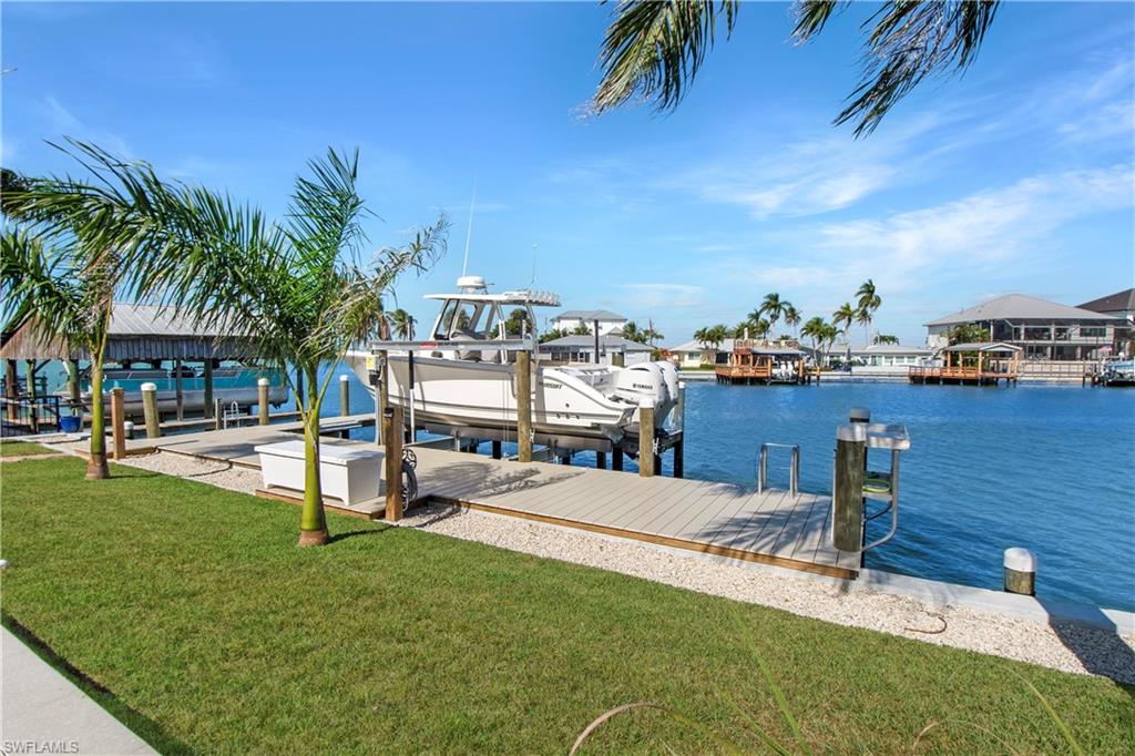 190 Tahiti Circle Naples, FL 34113 - Photo 4 of 32 a view of a swimming pool with a table and chairs