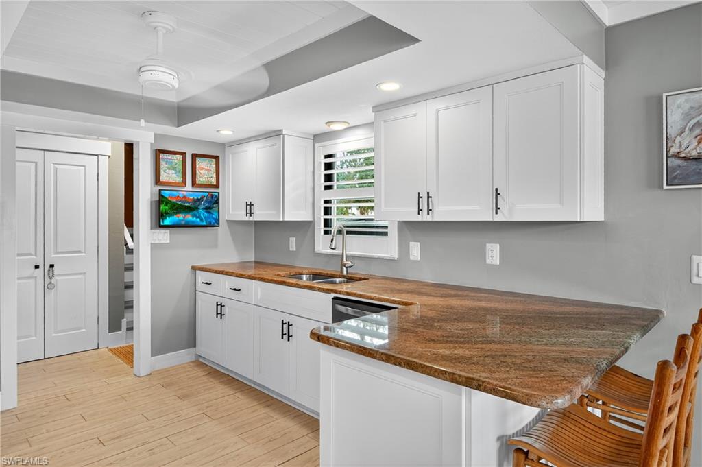 190 Tahiti Circle Naples, FL 34113 - Photo 10 of 32 a kitchen with stainless steel appliances granite countertop a sink stove and cabinets
