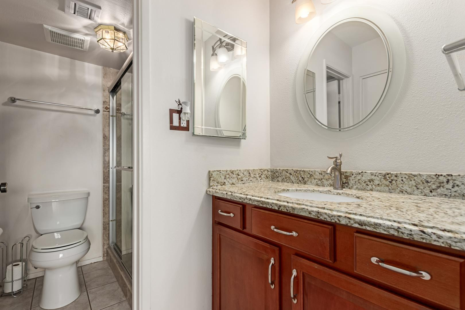 7436 East Chaparral Road, Unit B213 Scottsdale, AZ 85250 - Photo 11 of 27 a bathroom with a granite countertop toilet a sink and a mirror