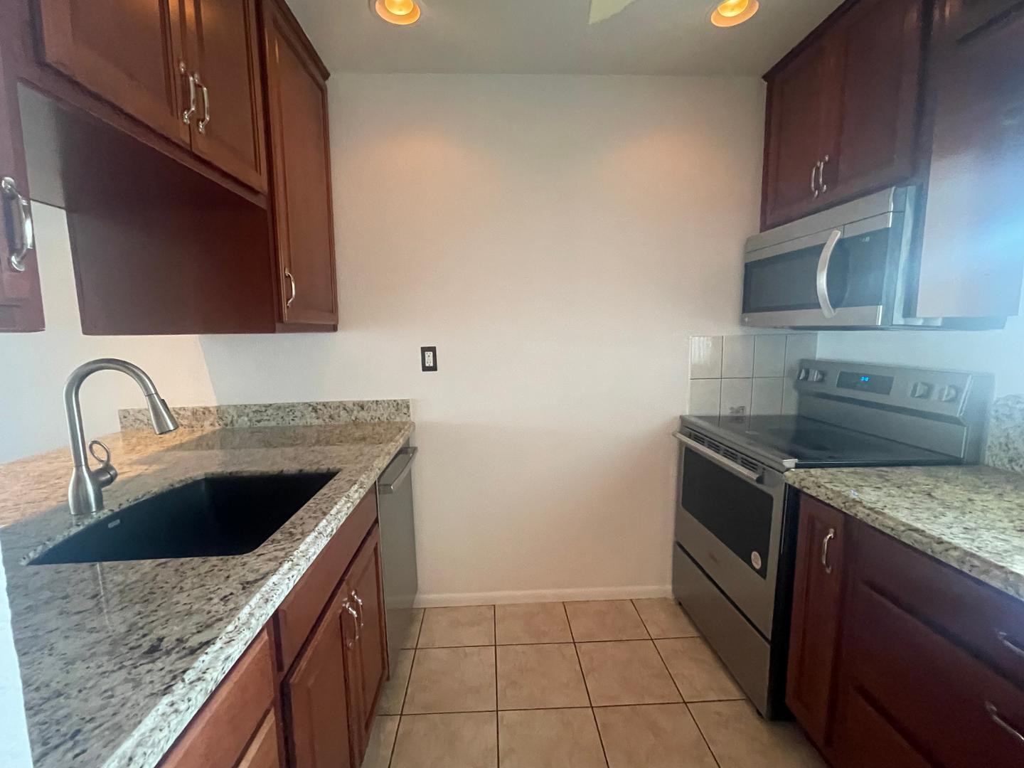 7436 East Chaparral Road, Unit B213 Scottsdale, AZ 85250 - Photo 15 of 27 a kitchen with a sink stove top oven and cabinets