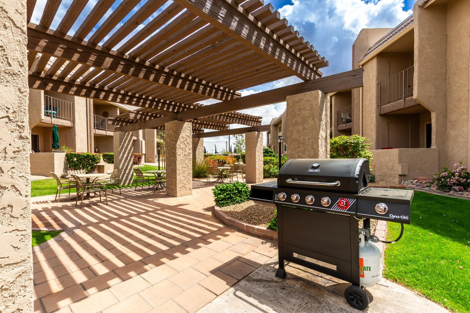 7436 East Chaparral Road, Unit B213 Scottsdale, AZ 85250 - Photo 20 of 27 a view of a patio with table and chairs with wooden floor and fence