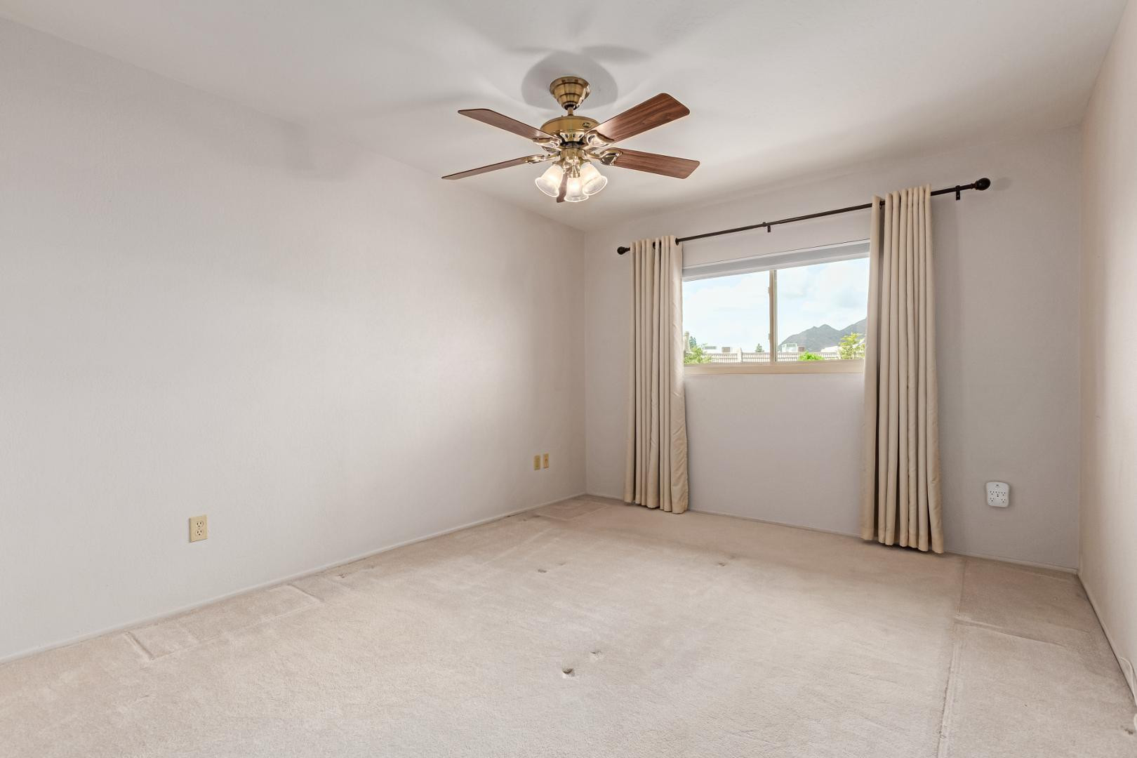 7436 East Chaparral Road, Unit B213 Scottsdale, AZ 85250 - Photo 8 of 27 an empty room with windows and fan
