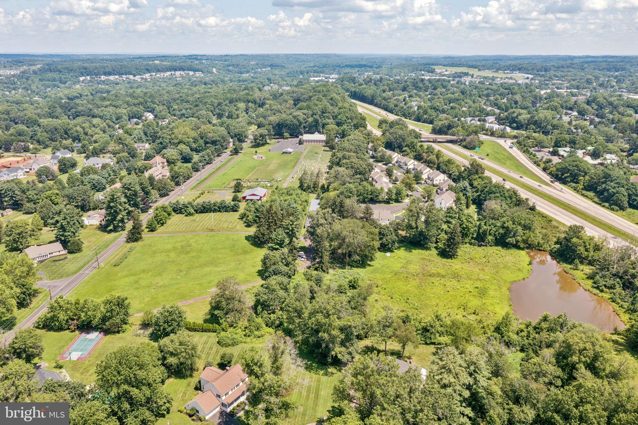 925 East Sandy Ridge Road Doylestown, PA 18901 - Photo 7 of 8 an aerial view of residential houses with outdoor space and trees all around