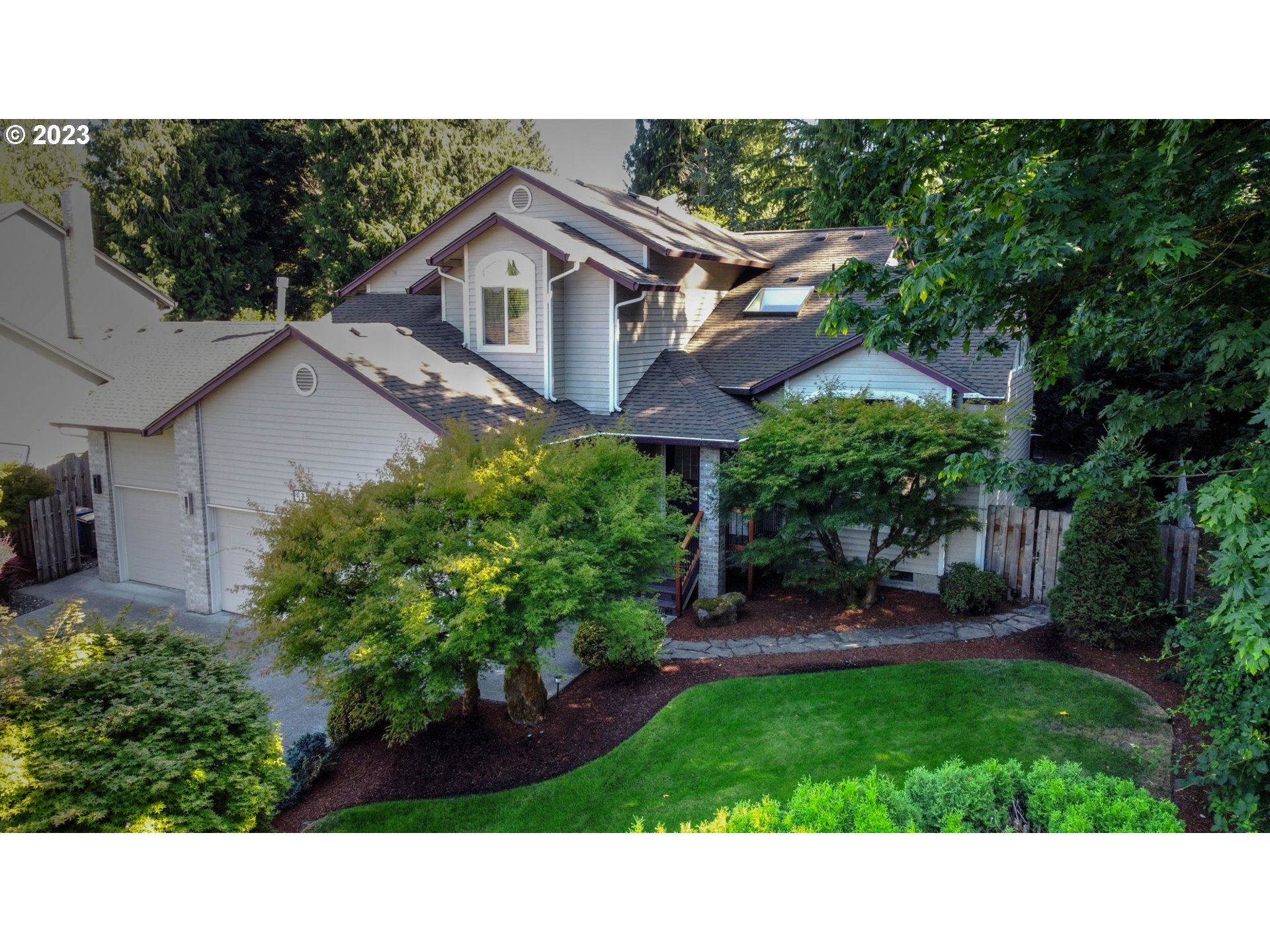 a black and white house with a yard