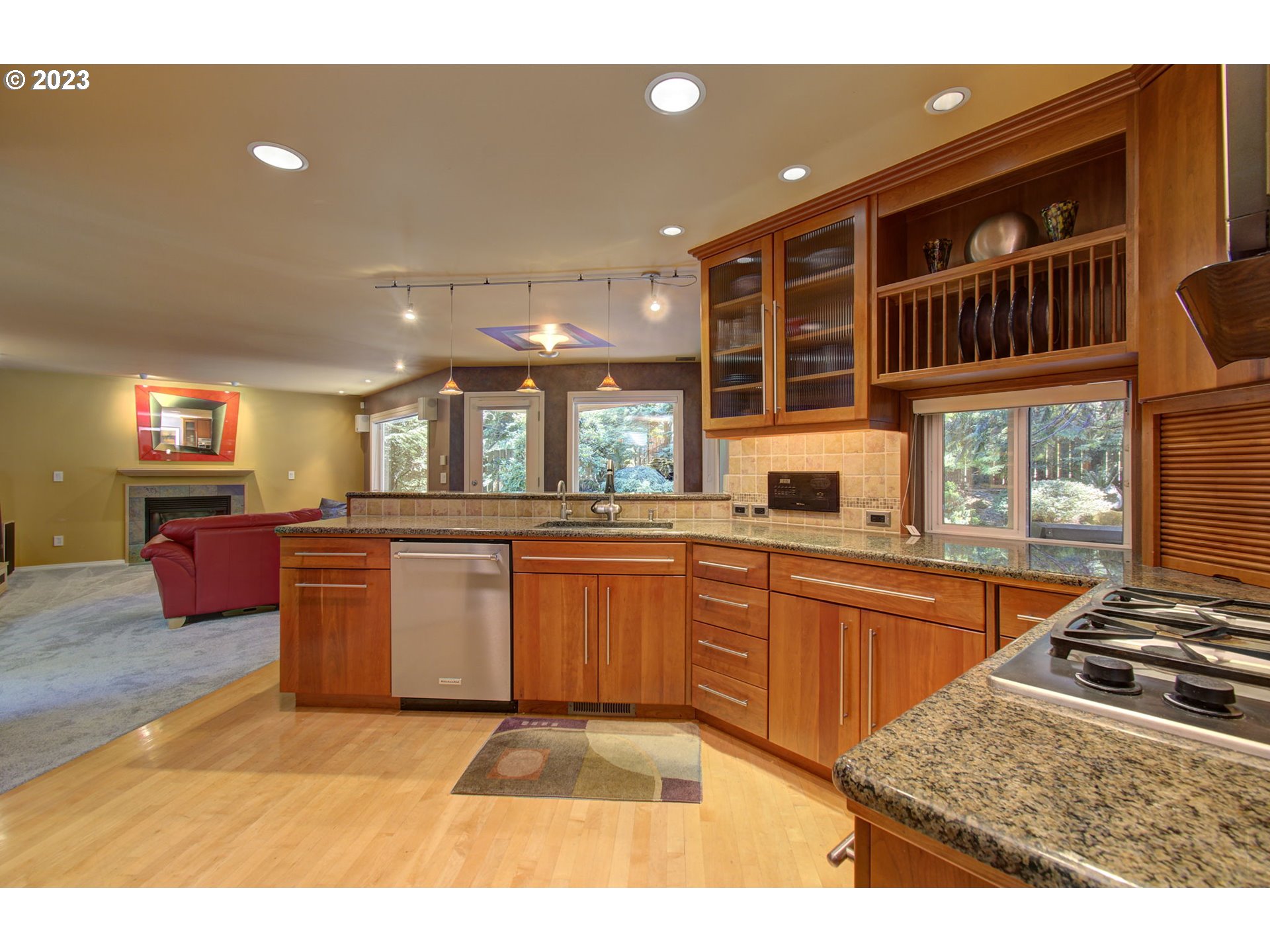 2407 Northeast 165th Street Ridgefield, WA 98642 - Photo 11 of 46 a kitchen with stainless steel appliances granite countertop a stove a sink and a microwave