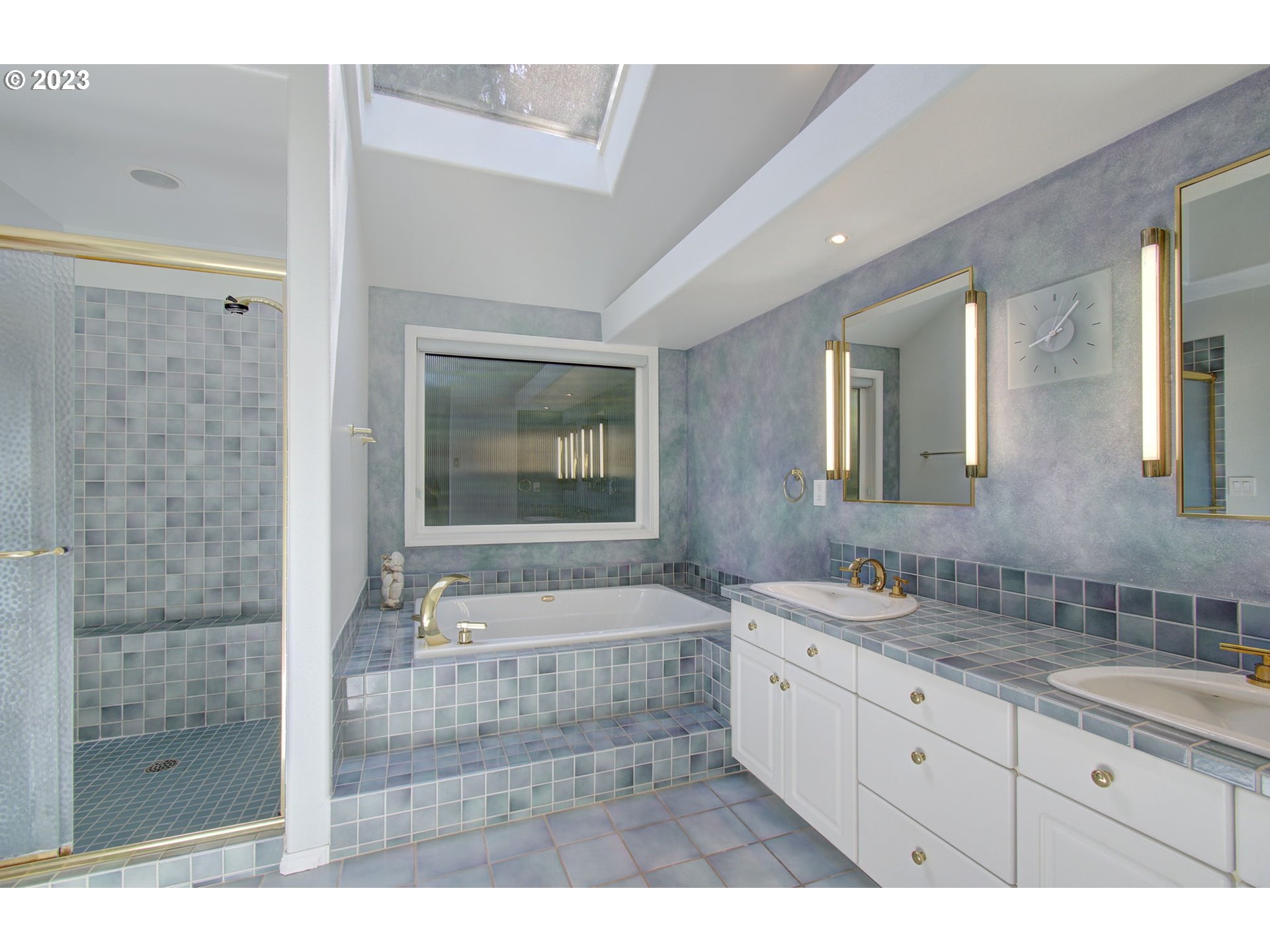 2407 Northeast 165th Street Ridgefield, WA 98642 - Photo 26 of 46 a spacious bathroom with a granite countertop sink a mirror and shower