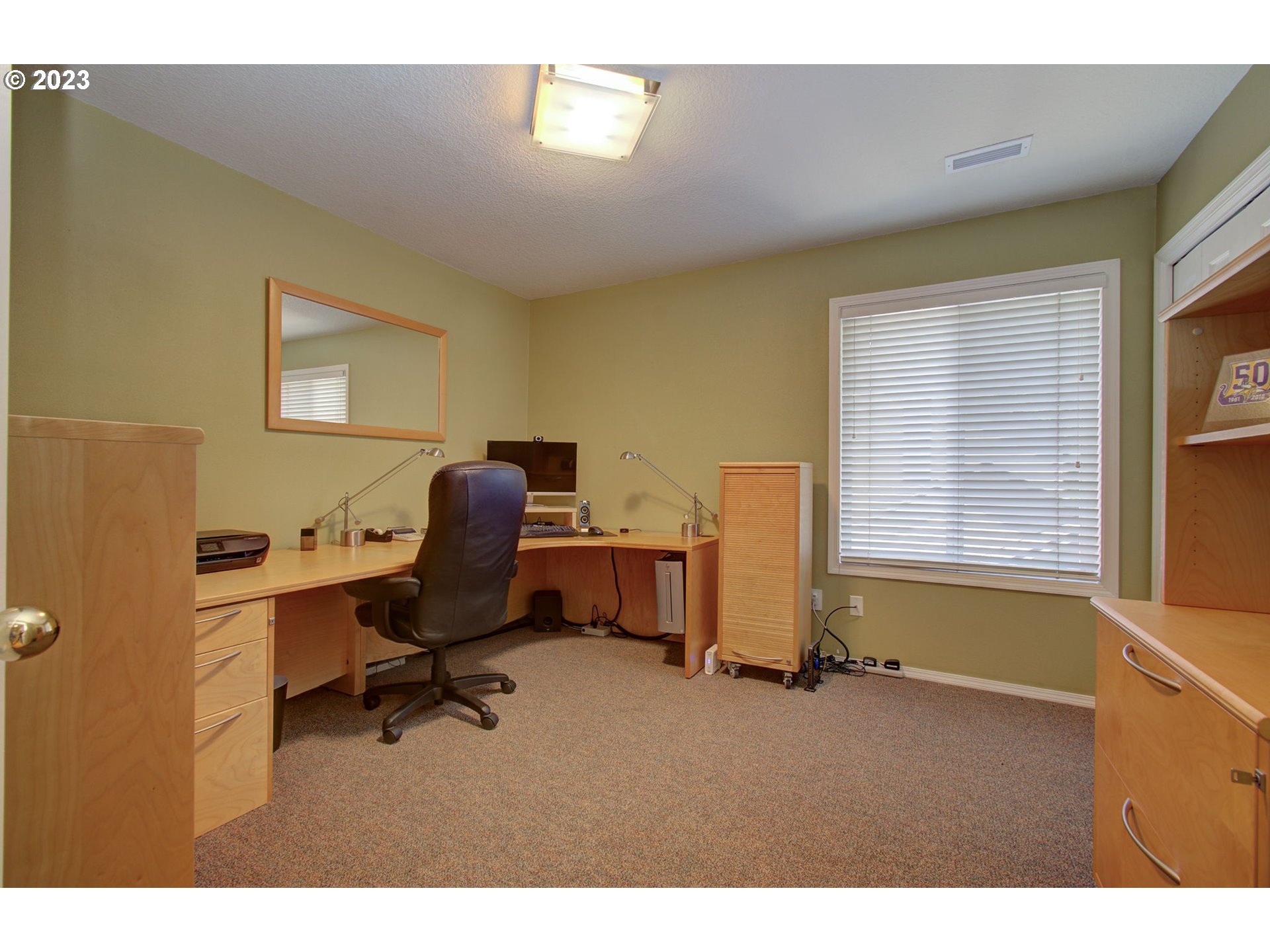 2407 Northeast 165th Street Ridgefield, WA 98642 - Photo 29 of 46 a workspace with furniture and a window