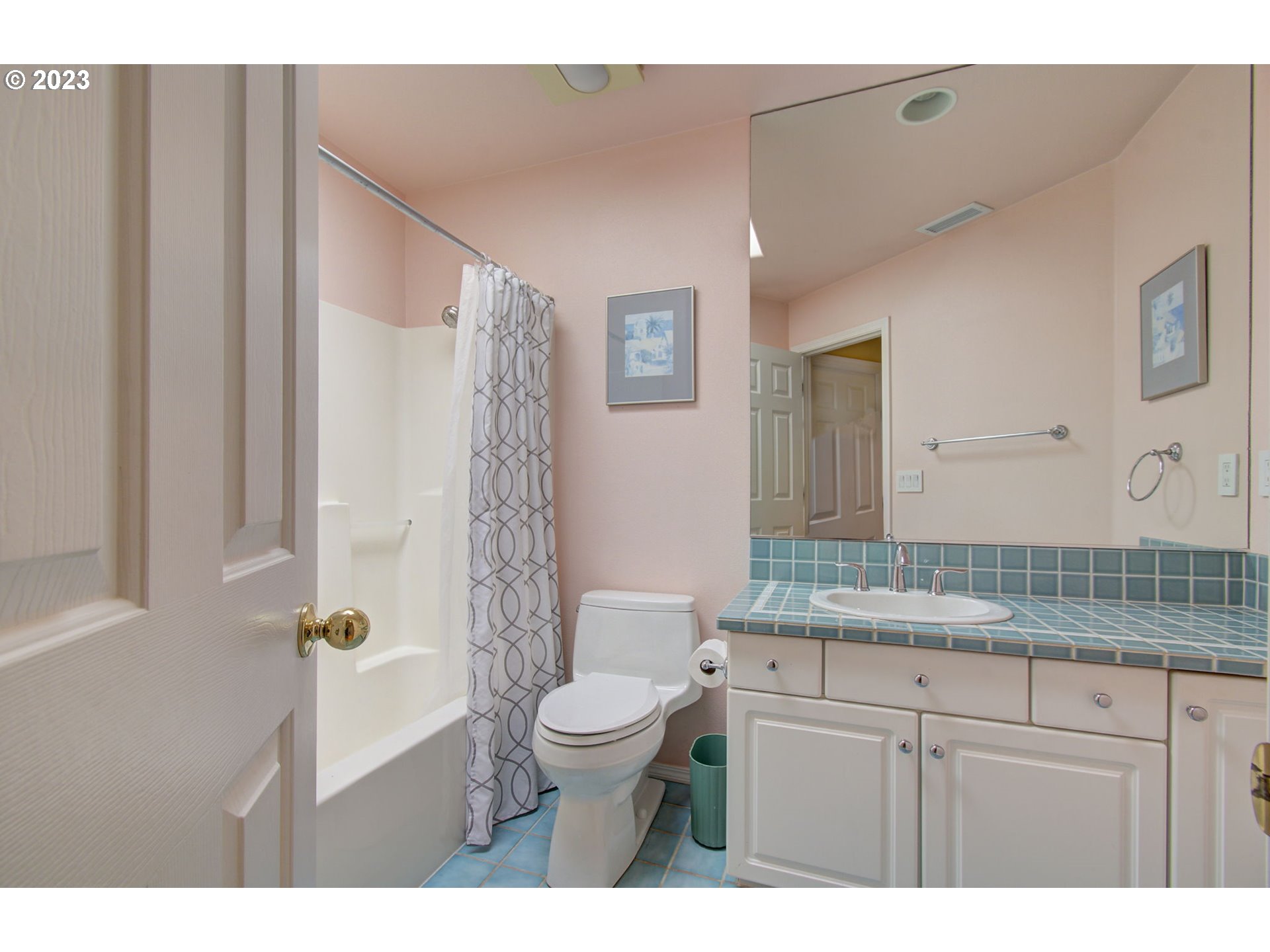 2407 Northeast 165th Street Ridgefield, WA 98642 - Photo 31 of 46 a bathroom with a granite countertop sink a toilet a mirror and shower